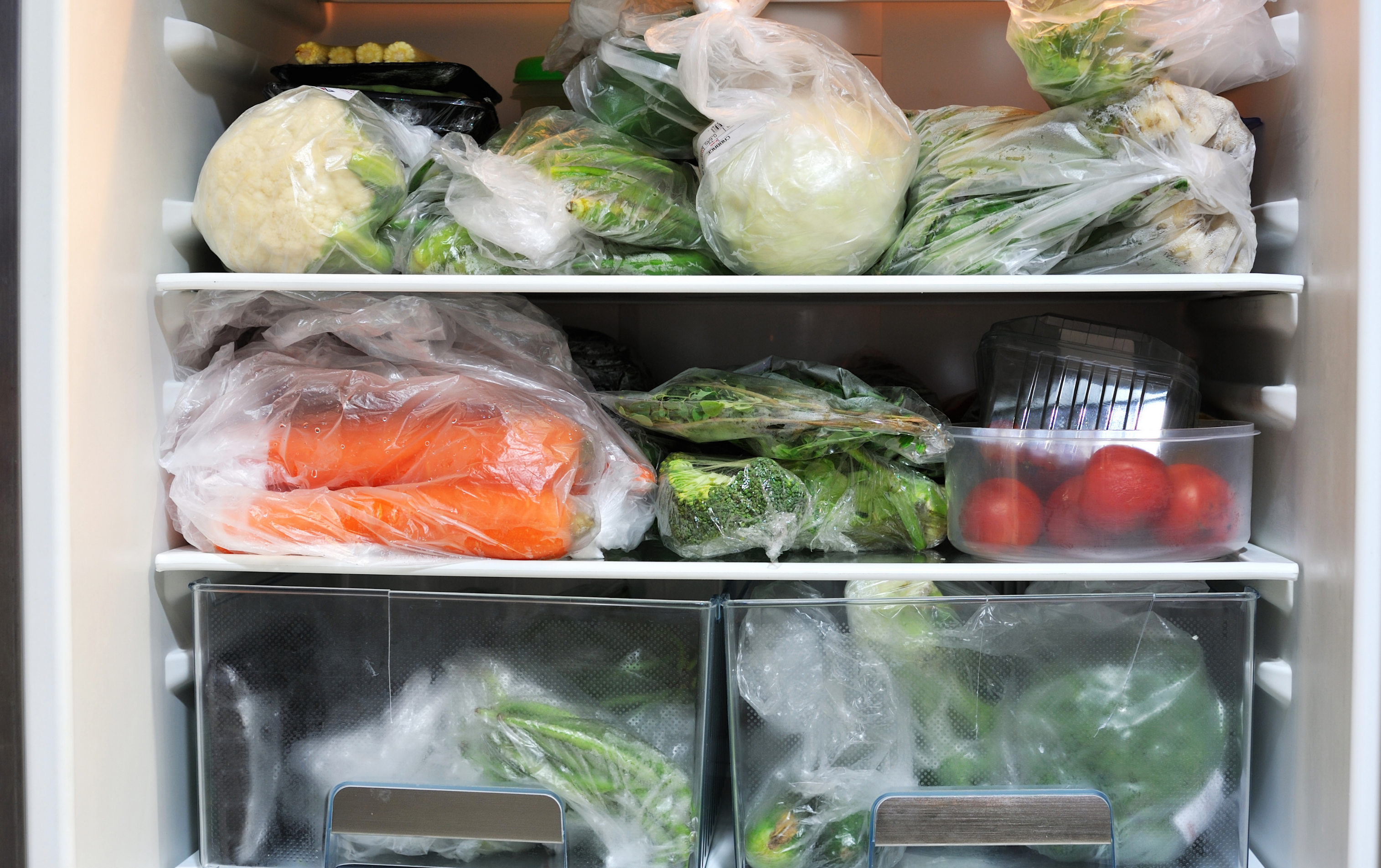 Inside of a fridge filled with produce.