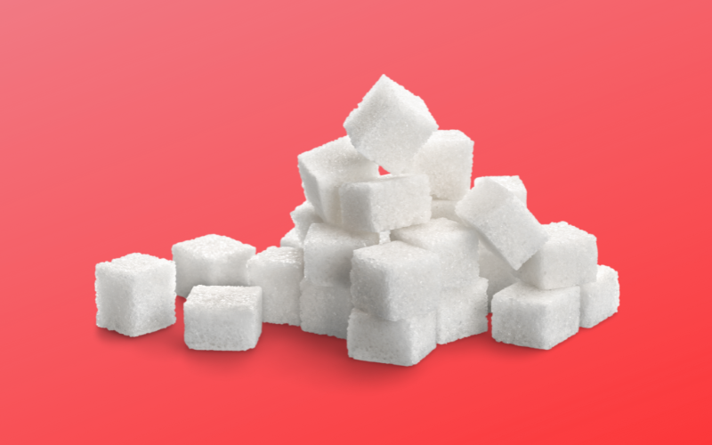 Stack of sugar cubes on hot pink background